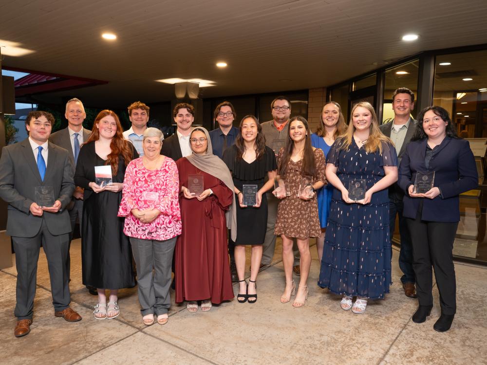 A large group of people pose for a group photograph