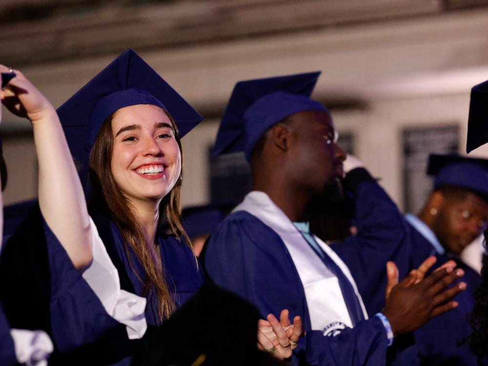 students clapping after moving tassel from right to left