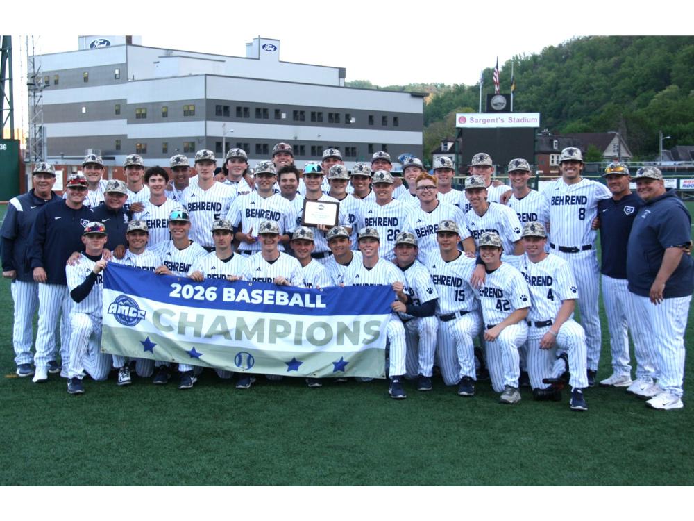 The Penn State Behrend baseball team poses with the AMCC championship banner.