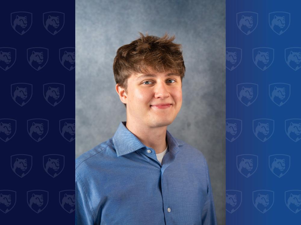 headshot of man in blue shirt