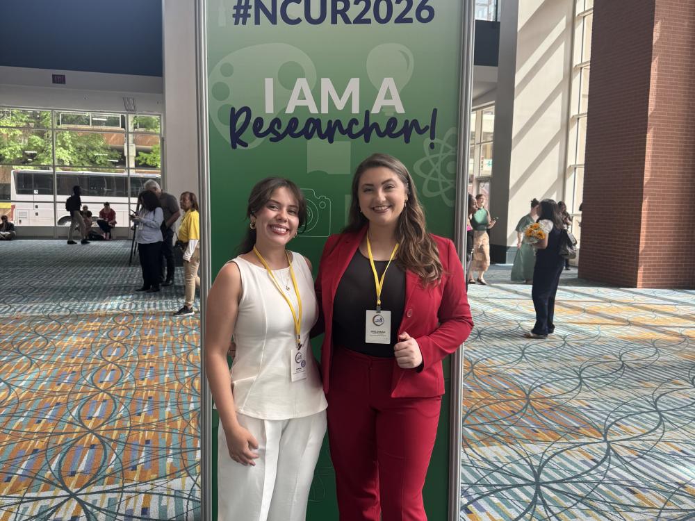 Donna Hercules and Kaelonnah Darlich posing in conference center