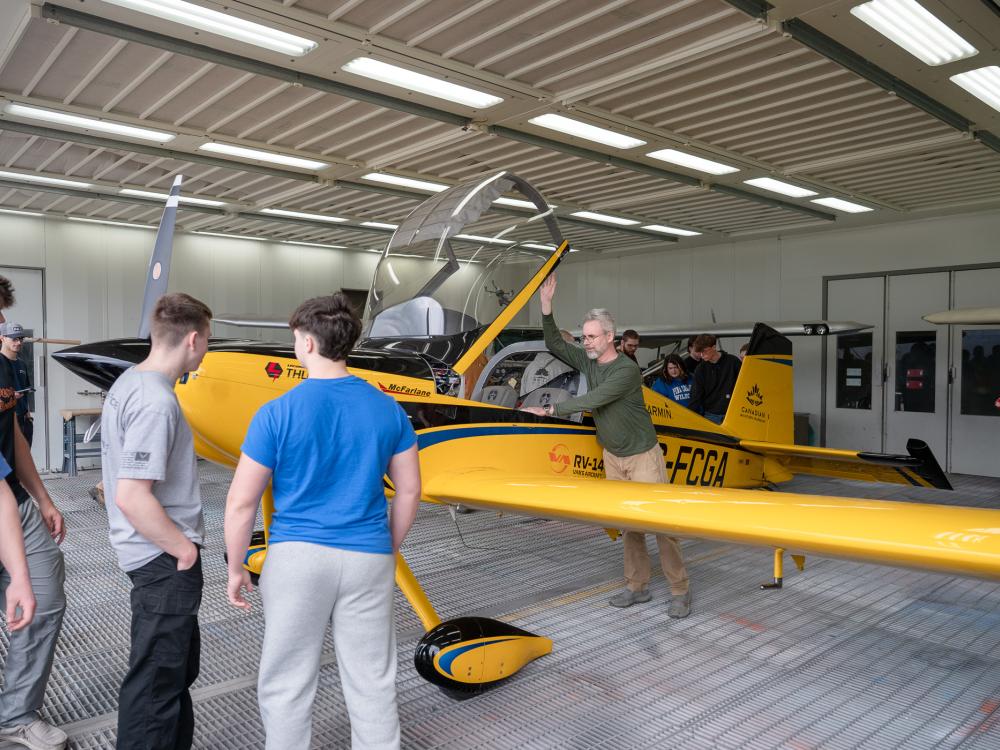A small group of people in an aviation engines school