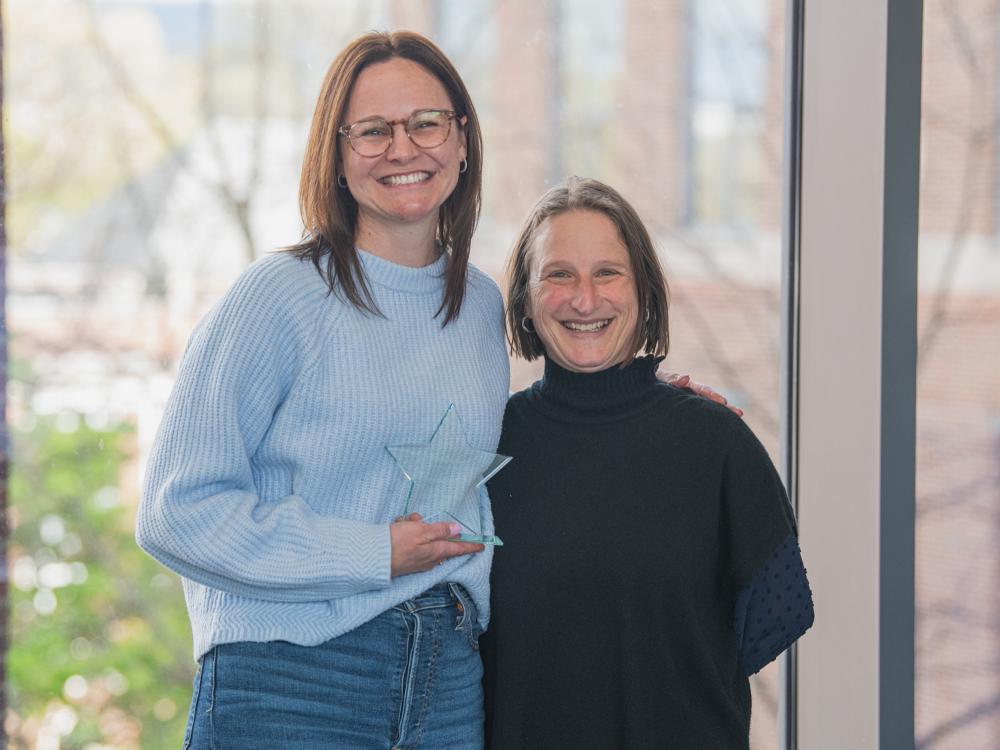 Janine Kwapis and Dean Tracy Langkilde posing with an award.