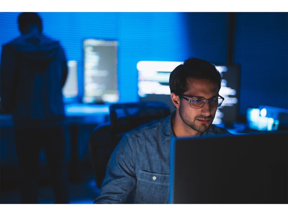 Person sitting at desk and working at computer