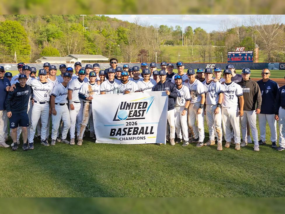 Penn State Harrisburg baseball team stands with a banner that says 2026 United East Champions