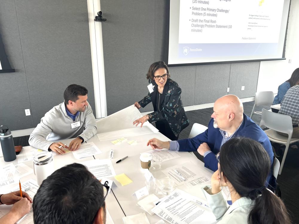Sadan Kulturel-Konak works with a table on a co-creation session at the Food Security and Healthy Futures Symposium.
