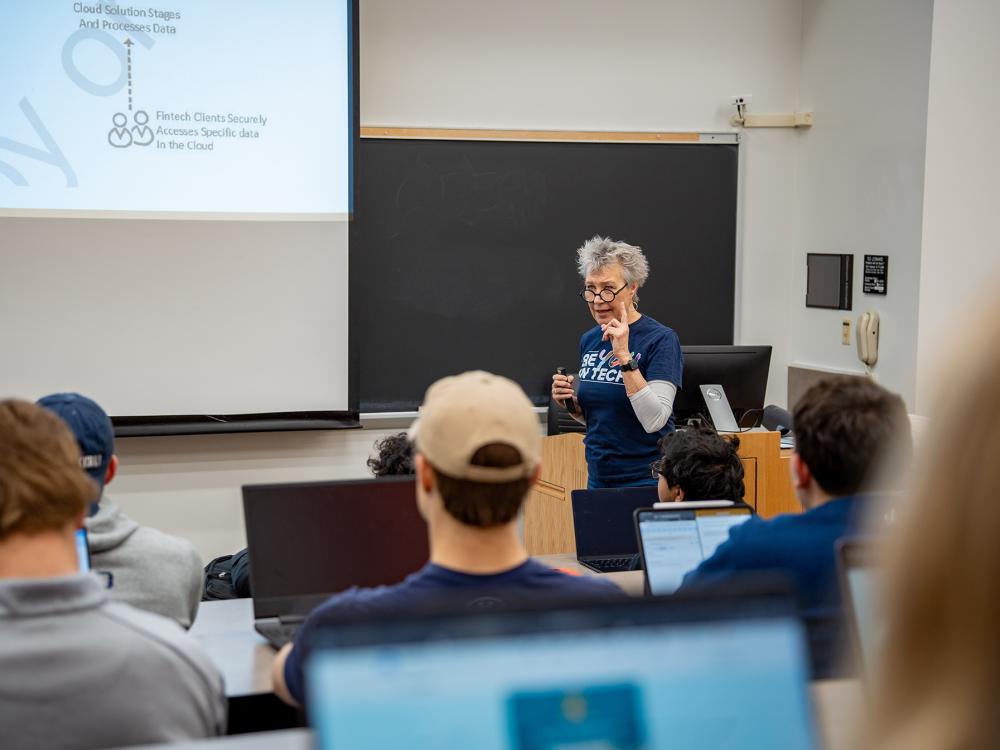 Rosalie Ocker teaches a class in front of a large screen