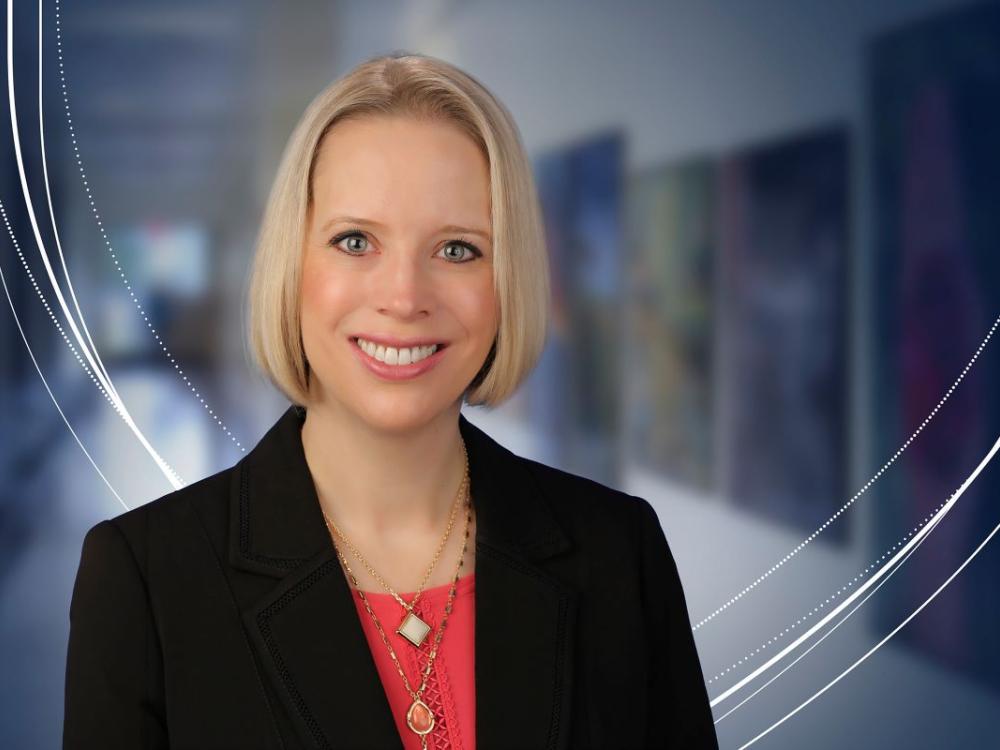 Jennifer Kraschnewski, MD, MPH, poses for a professional portrait in front of a blurred indoor background.