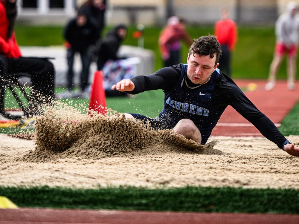 Penn State Behrend student-athlete Lee Qualk competes in the long jump.