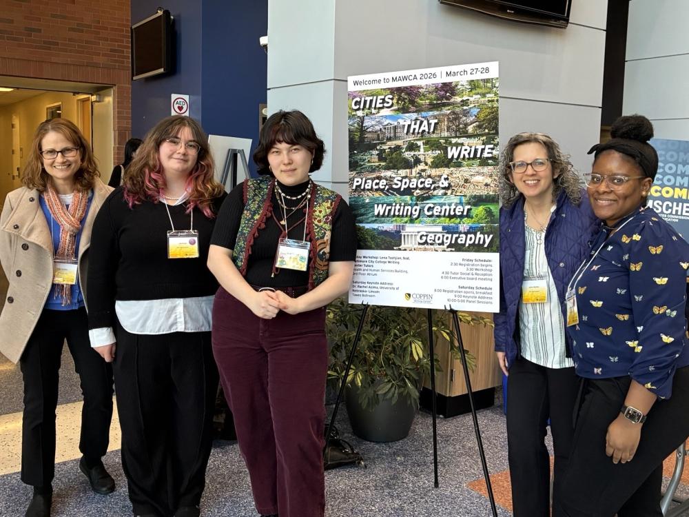 Student peer tutors pose for a photo in front of a poster at the MAWCA writing conference