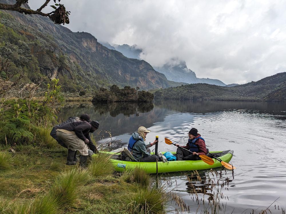 Graduate students on a boat collecting core samples