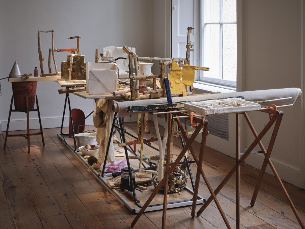An art installation made with a collection of found materials such as wood, metal and fabric