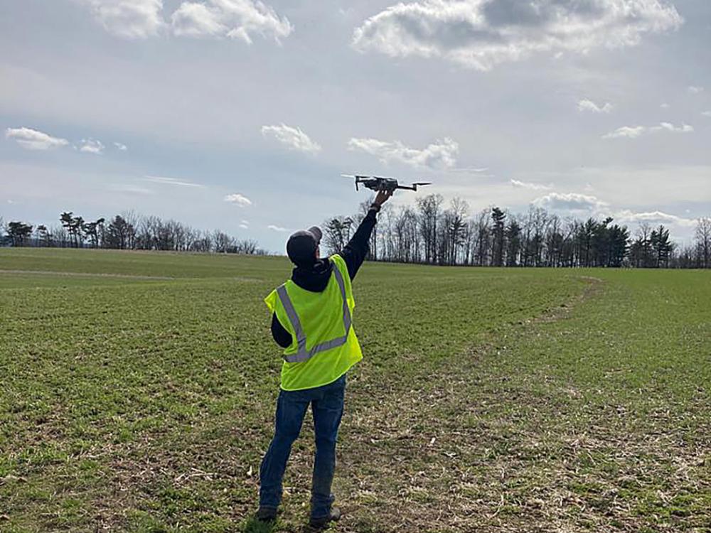 Person with drone in farm field