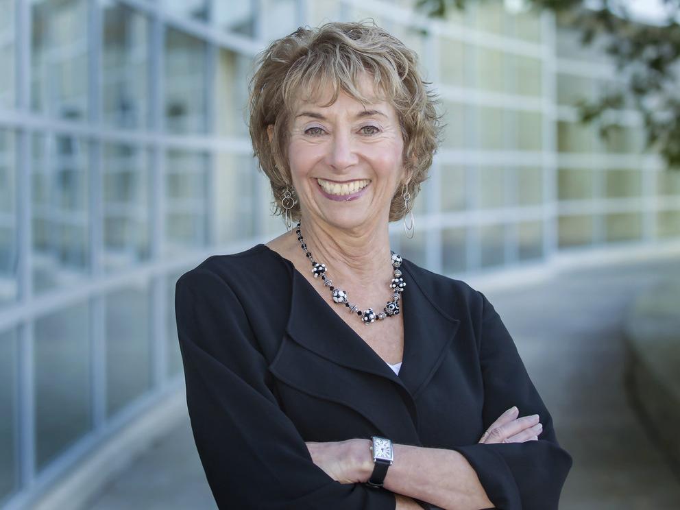 A photo of a smiling Linda Trevino standing outside of the Business Building