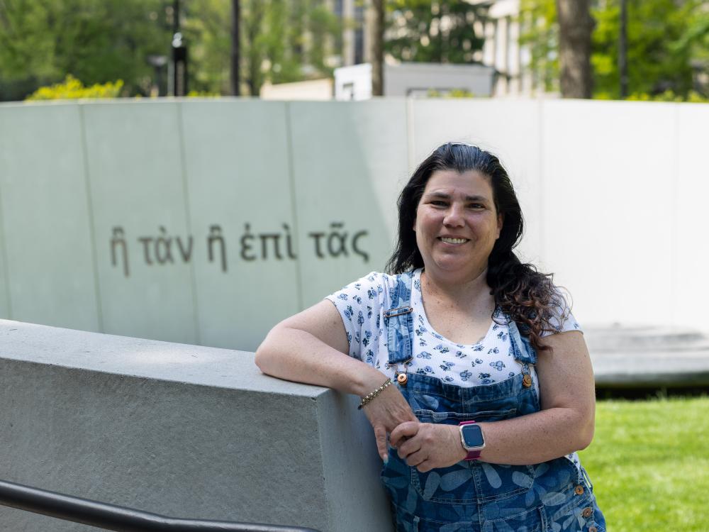 Mary Tonge leans on the Penn State Veterans Plaza.