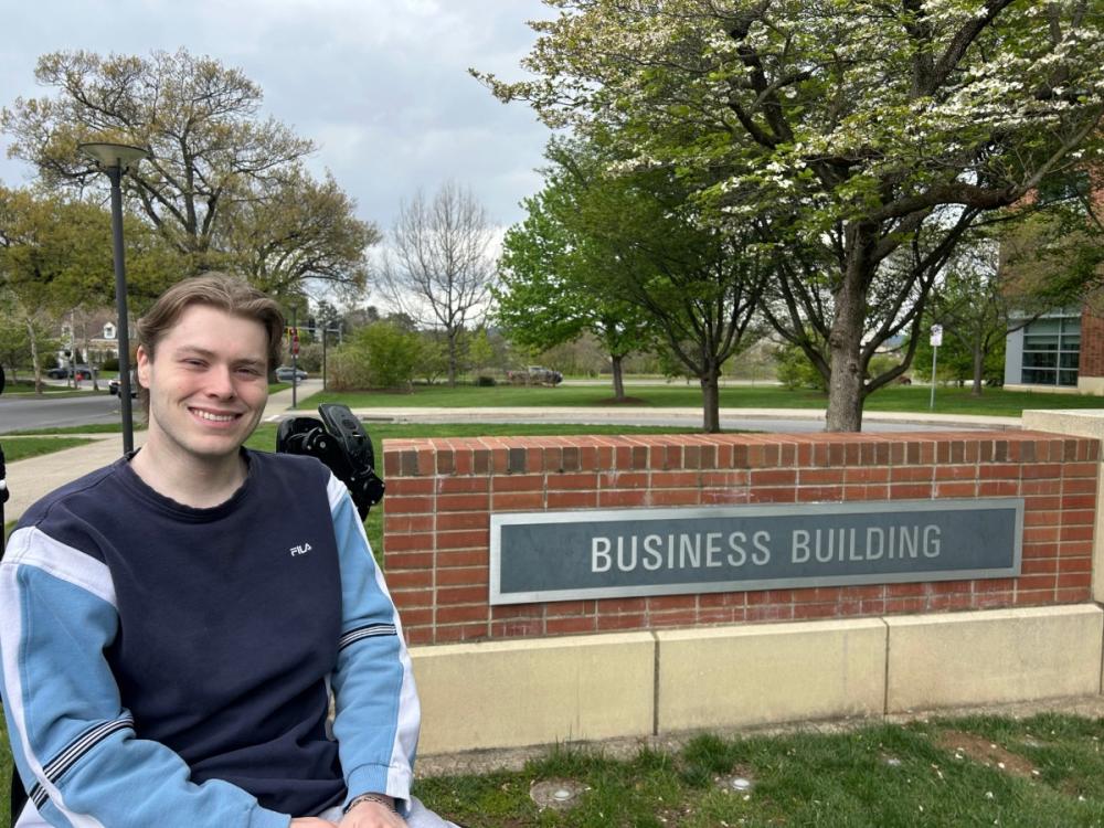 Portrait of Patrick Hoey in front of the Business Building