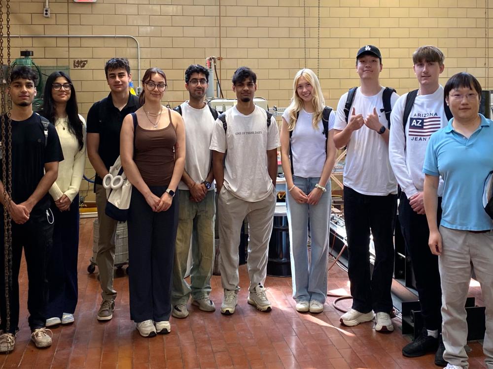 A group of students pose for a photograph with Hongtao Sun.