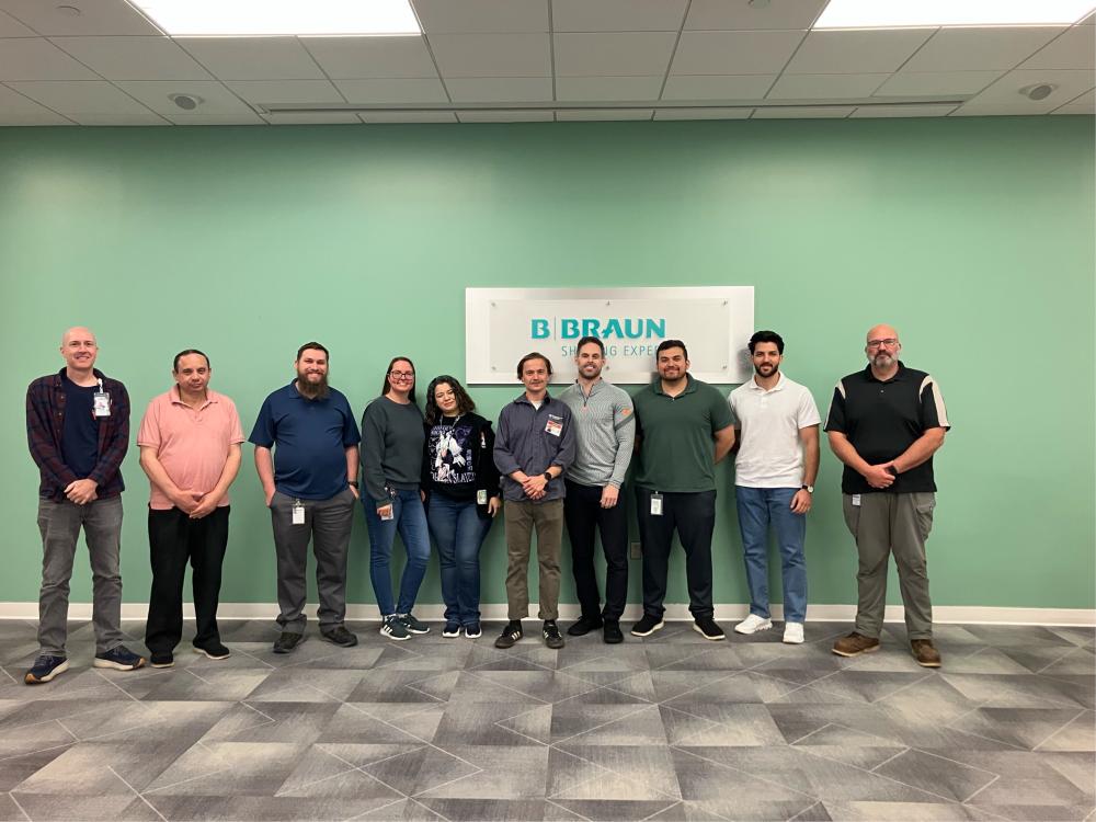 A group of people stand and pose for a photo