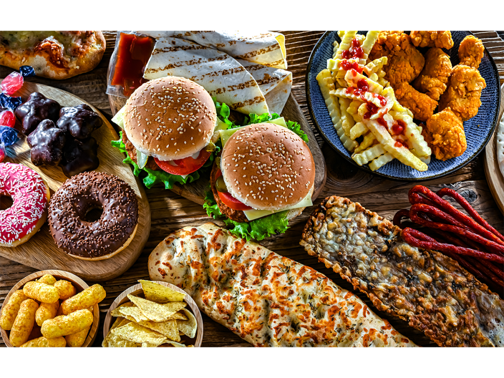 Assortment of burgers, fries, donuts and other junk food