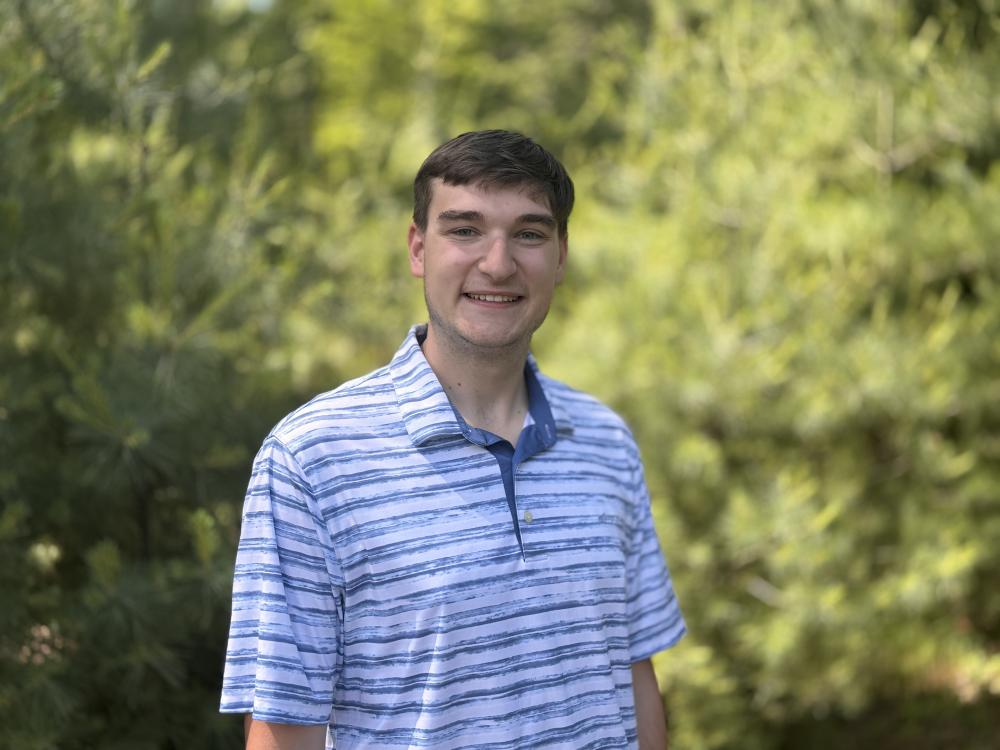 Ryan Denicola standing outside, smiling
