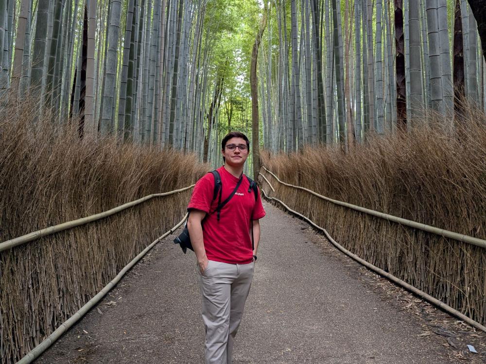 Matias Moreno standing on gravel path in a bamboo forest
