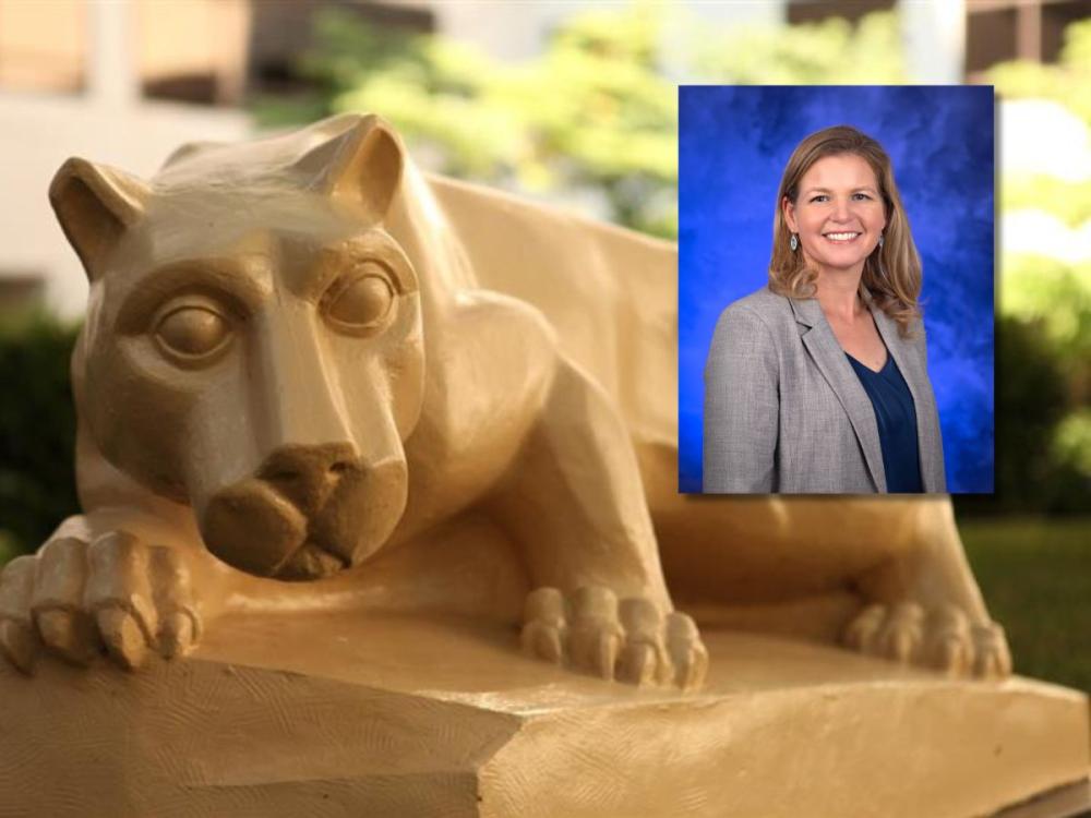 A close-up photo of a Nittany Lion statue resting on a stone base outdoors, with a professional portrait of a smiling woman in a gray blazer overlaid in the upper-right corner against a blue studio background.