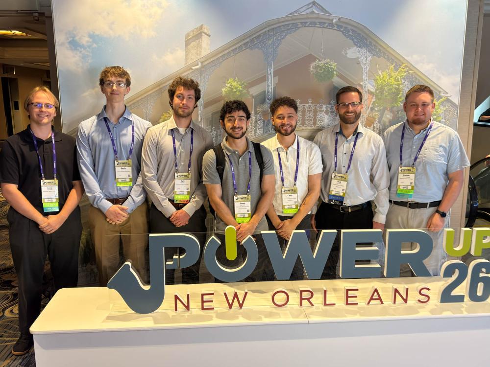 A group of seven students post for a photo