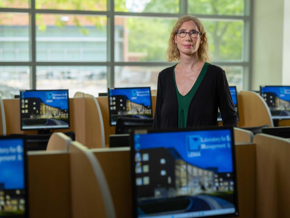Lisa Posey, standing in a computer lab