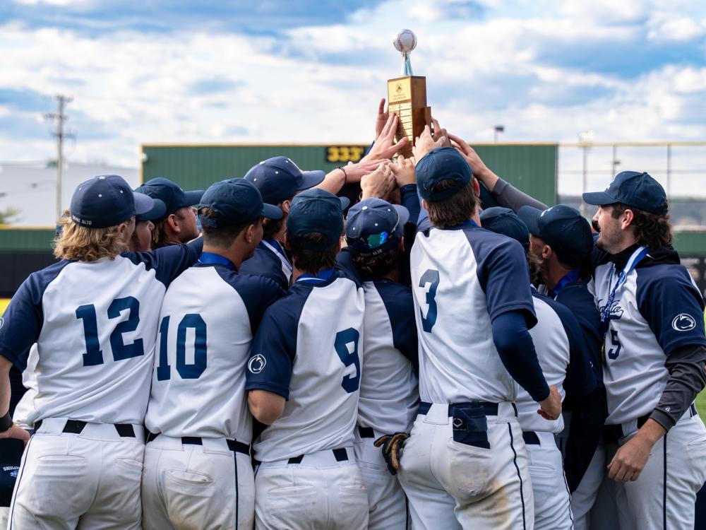 A group of players are hold a trophy.