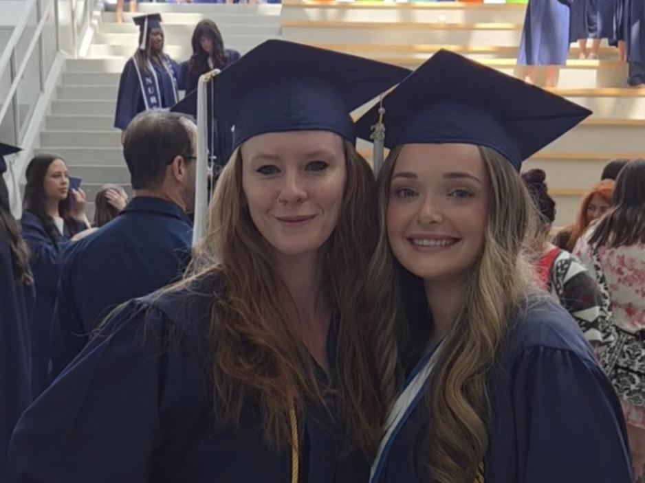 Amber Bisking and Lexy Fortney in graduation regalia