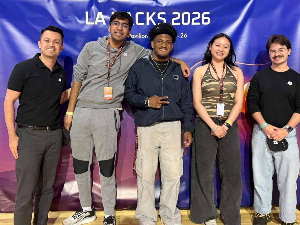 The three student engineers pose for a photo with representatives from Roblox