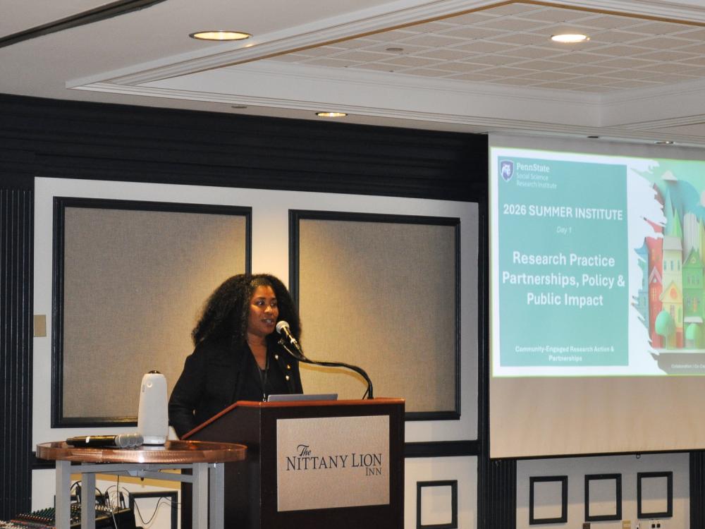 Dawn Witherspoon, CERAP co-director, welcomes attendees to the CERAP Summer Institute while standing behind a podium.