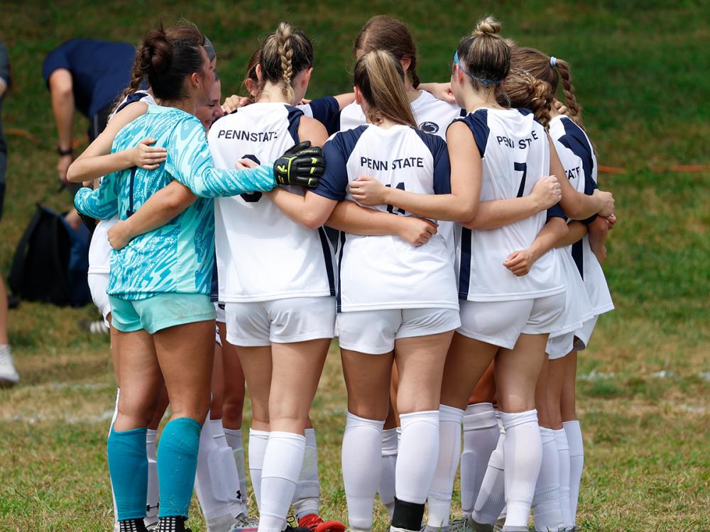 women's soccer team huddles pre-game