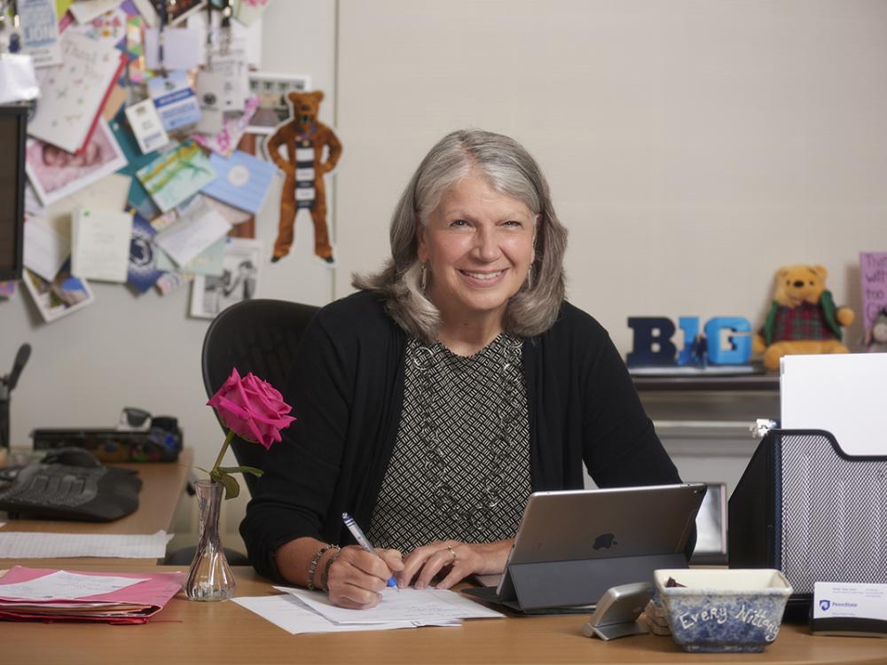 Mitch Kirsch sits at her desk with her laptop