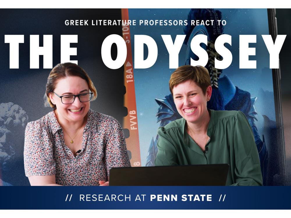 Two women sit in front of a laptop smiling. Images from a movie are projected behind them.