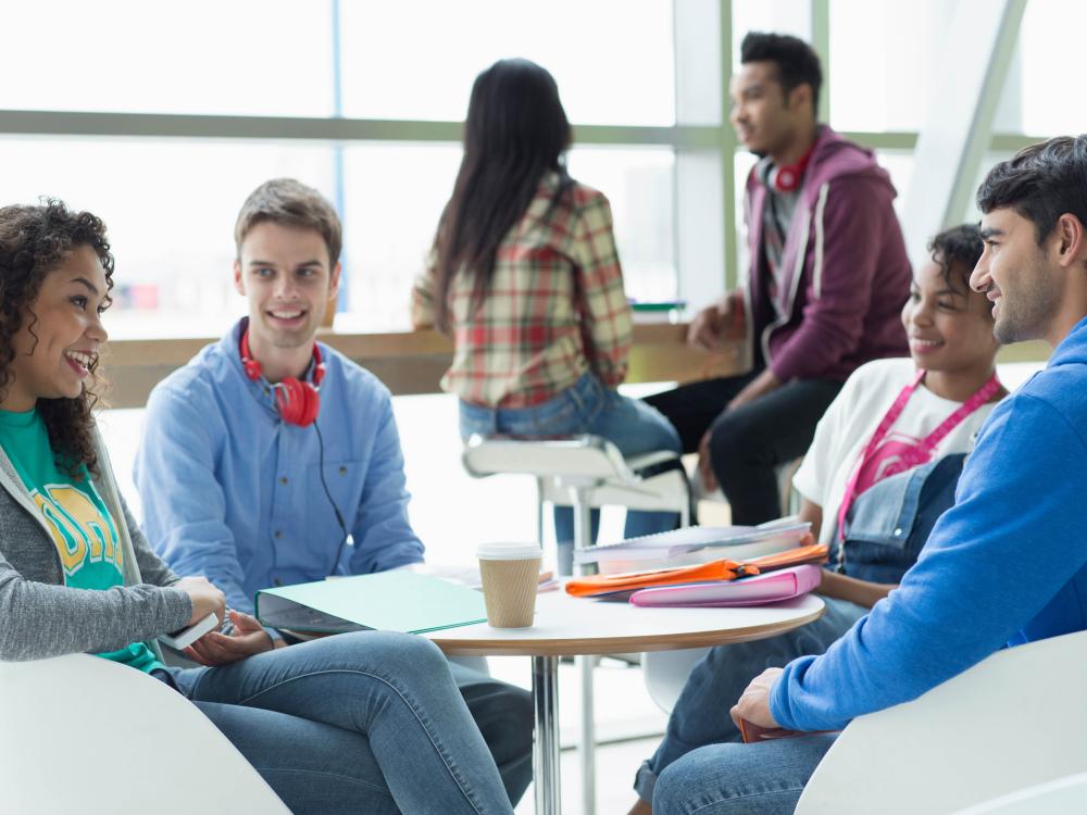 College students talking and studying in student lounge
