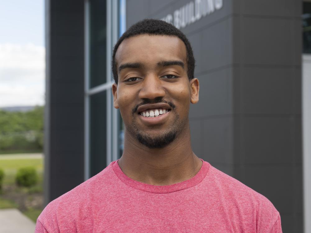 Penn State Scranton male student smiles in front of Engineering Building.