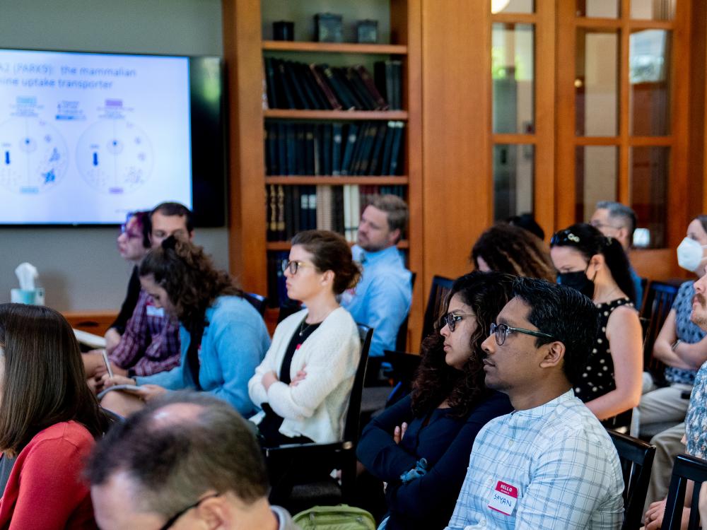 Audience members watching a speaker at the 2023 Neuroscience Institute retreat