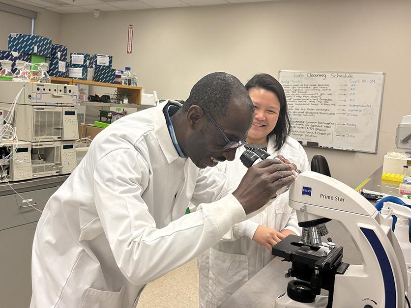 researchers at microscope