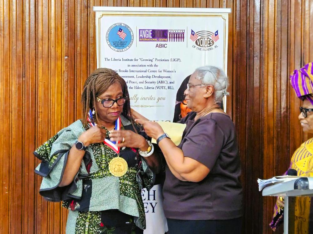 Patricia Jabbeh Wesley receives the Judge Emma Shannon Walser Medal during a recognition ceremony in Monrovia, Liberia.