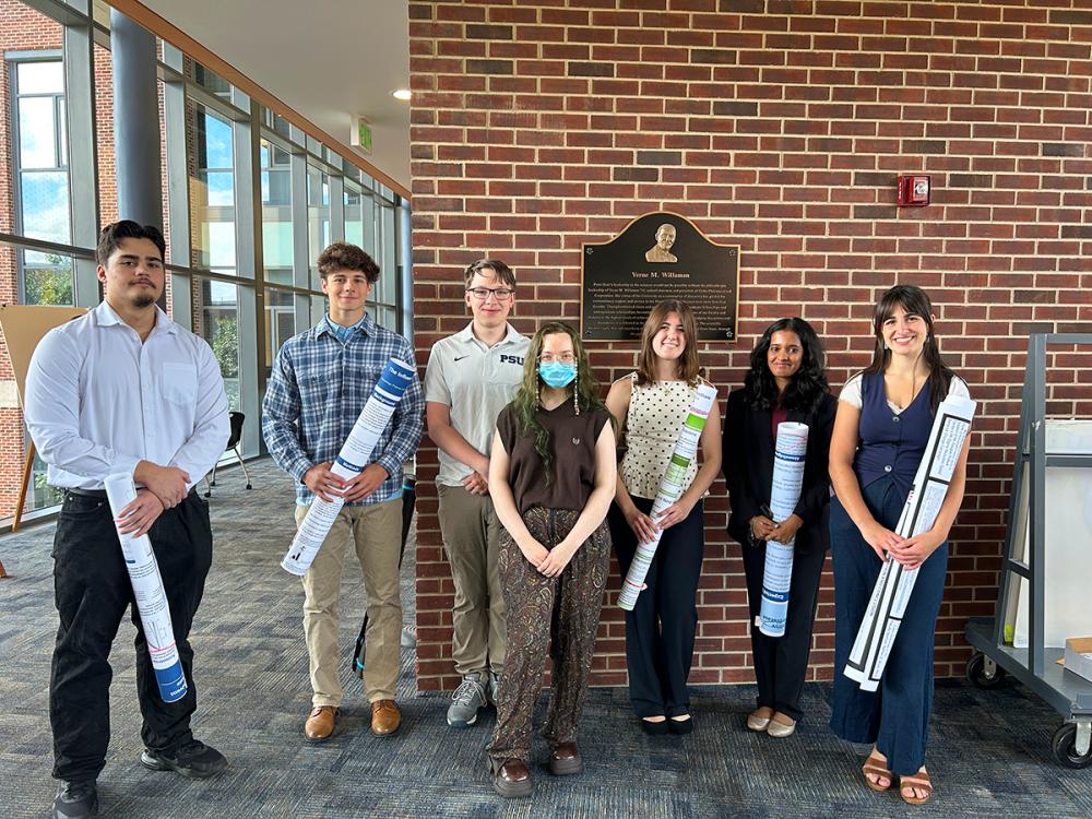 Bryce Grove, Samuel Albright, Kurt English, Tehya Dibert, Madison Riva, Ruth Vinu, and Abigail Hayes at the 2026 REU Summer Research Poster Symposium.
