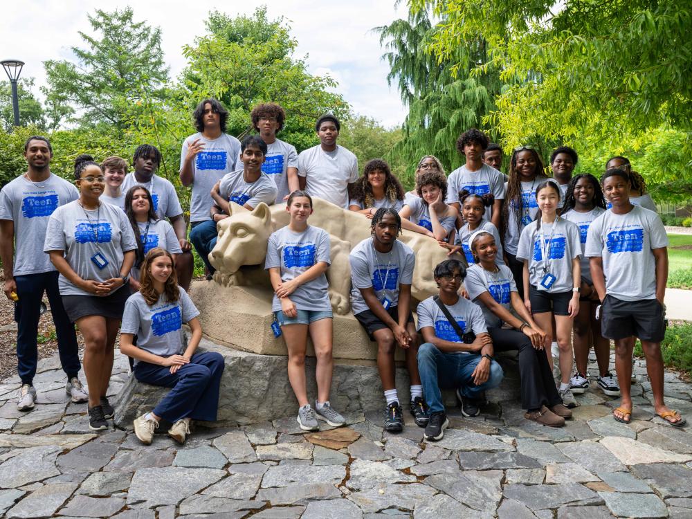 group of students around nittany lion statue