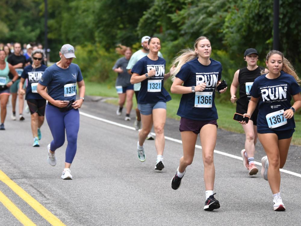 A group of women run during the Run for Women 5K at Penn State Behrend.