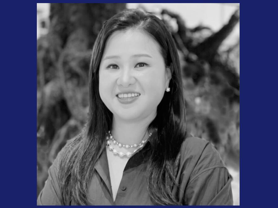 Asian woman with mid-length dark hair smiling
