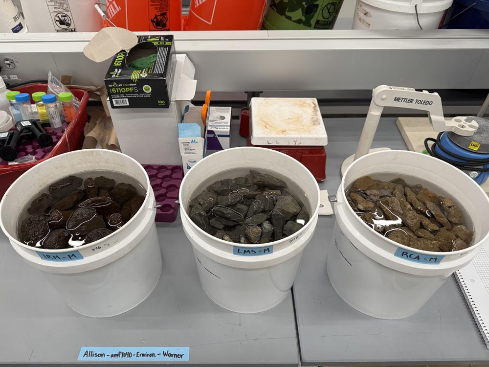 three buckets holding water and rocks