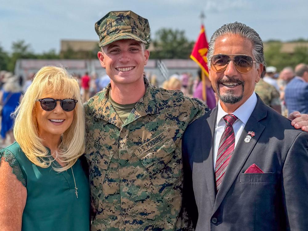 A photo of Betz in his military camo standing with his parents