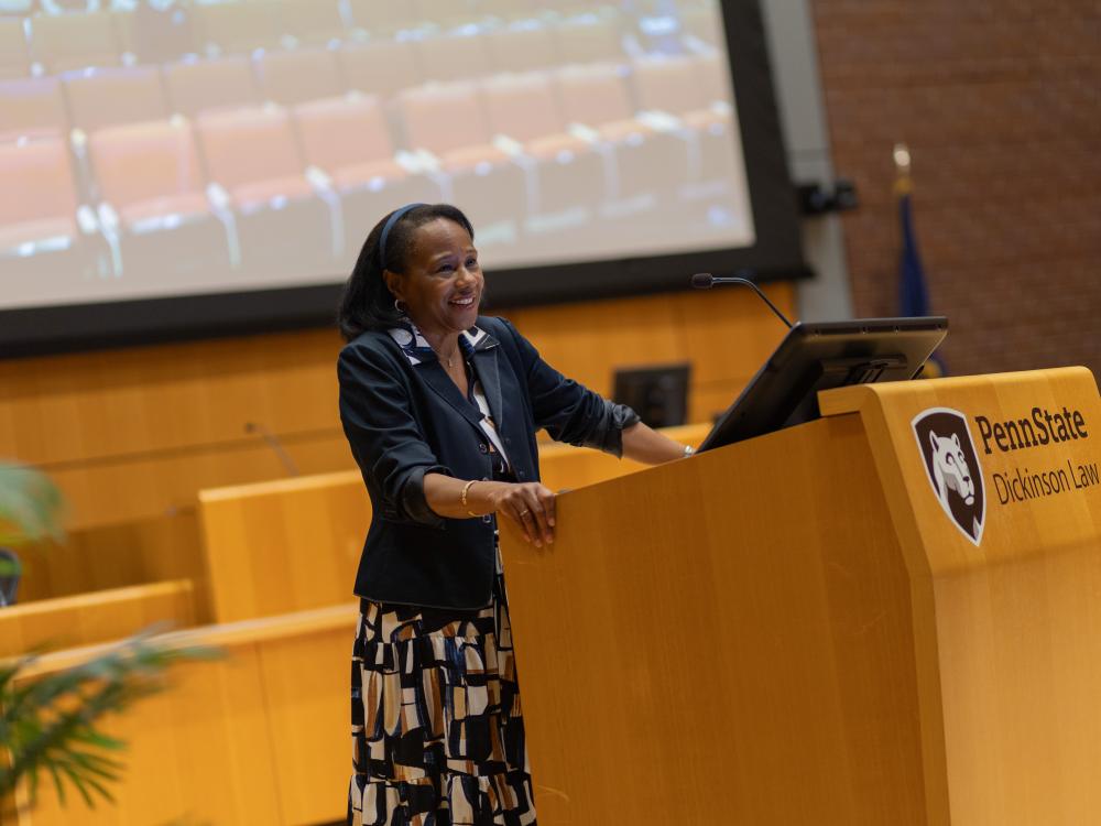 Black woman standing at a podium