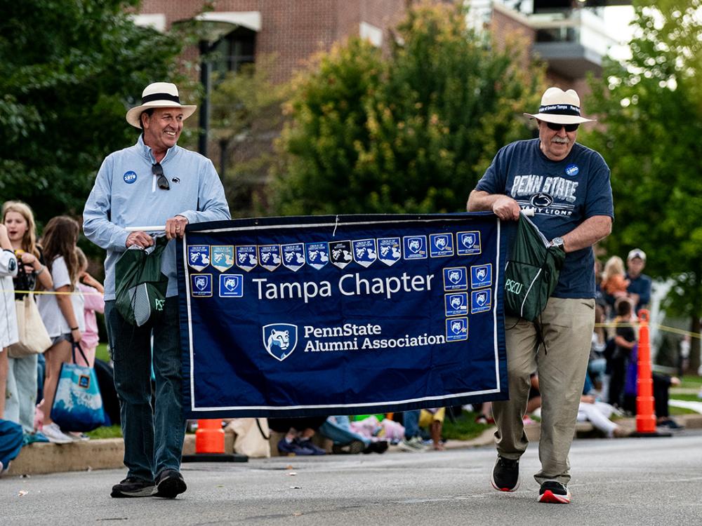Two men walking with banner