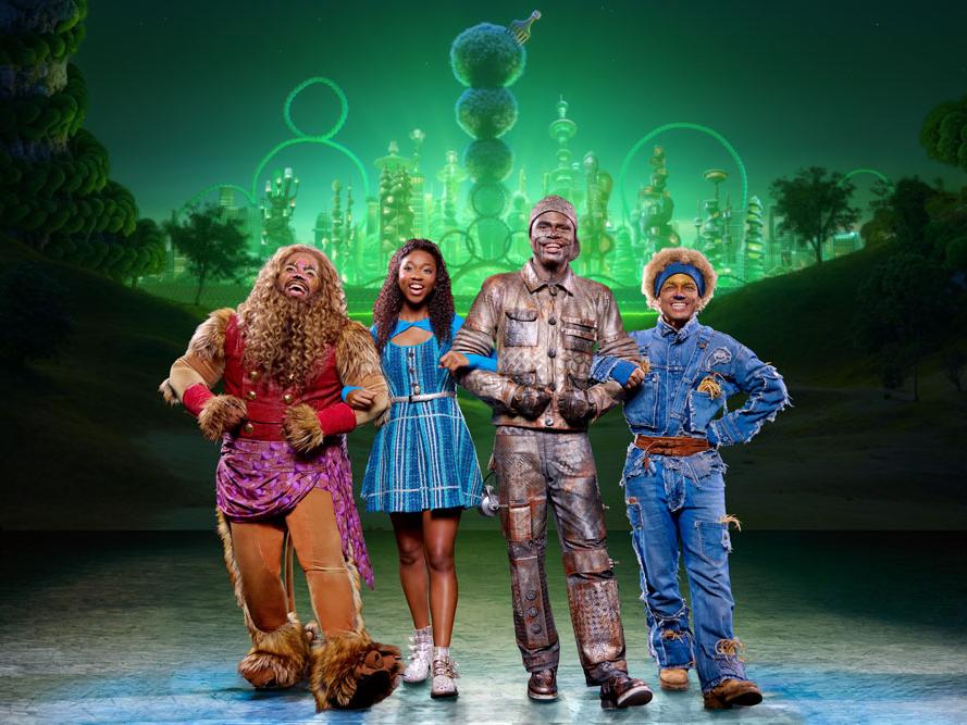 Four Black actors are dressed in costume for "The Wiz."