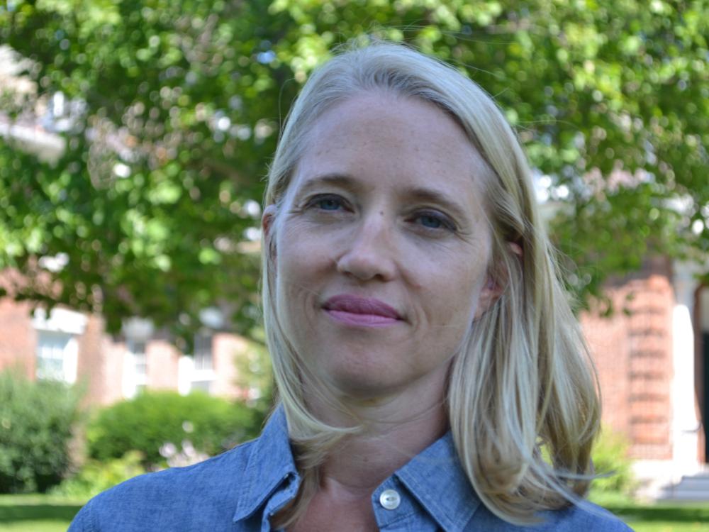 Ellen Wayland-Smith wearing a blue shirt and standing against outdoor backdrop